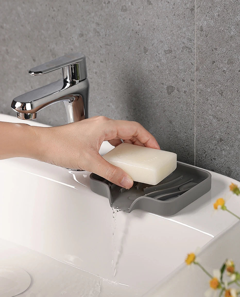 Hand picking up soap from dish holder