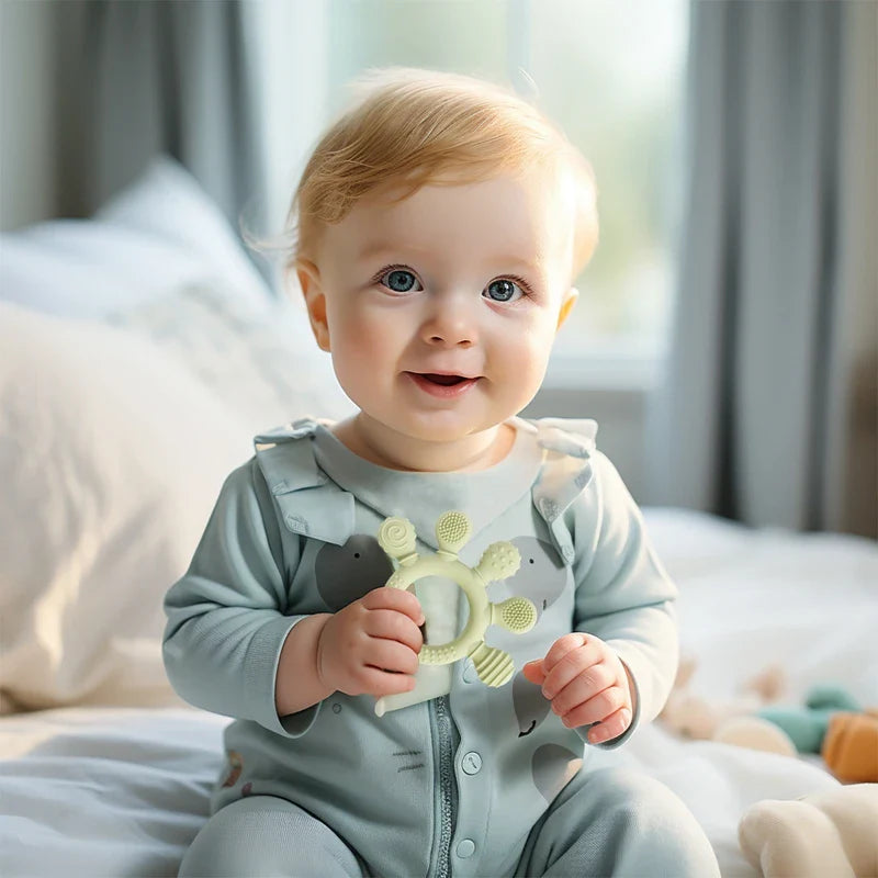 Baby holding Green Teether