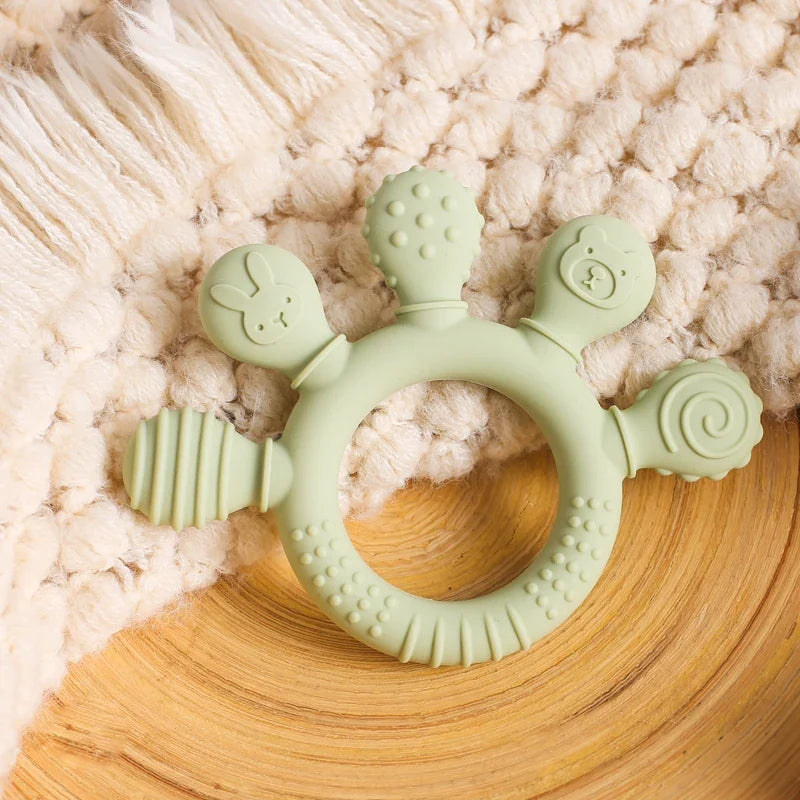 Green Teether on rug